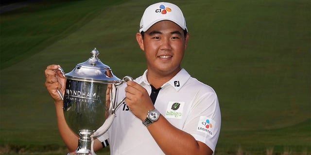 Joohyang Kim of South Korea poses with the trophy after winning the Wyndham Championship golf tournament, Sunday, June 7, 2022, in Greensboro, NC. 