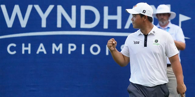 South Korea's Joohyoung Kim (right) reacts after winning the Wyndham Championship Golf Tournament on Sunday, August 7, 2022 in Greensboro, North Carolina. 