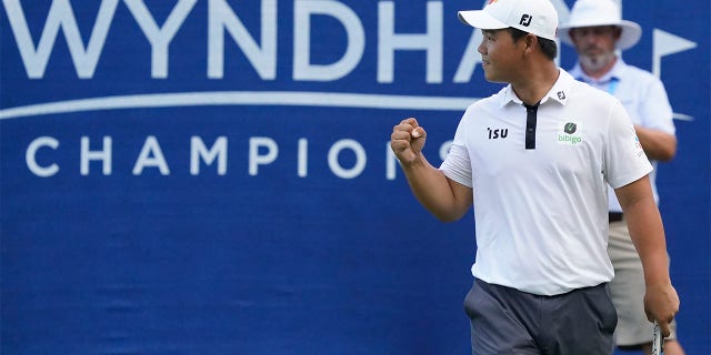 South Korea's Joohyoung Kim (right) reacts after winning the Wyndham Championship Golf Tournament on Sunday, August 7, 2022 in Greensboro, North Carolina. 