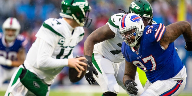 Jordan Phillips, #97 of the Buffalo Bills, pushes past Brandon Shell, #72, towards Sam Darnold, #14 of the New York Jets, during the first quarter at New Era Field on December 29, 2019 in Orchard Park, New York. New York defeats Buffalo 13-6.