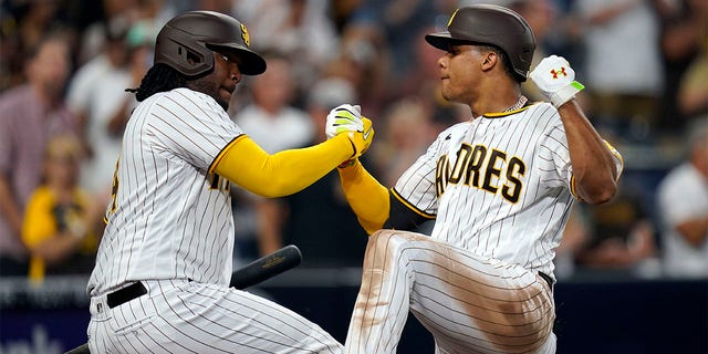 San Diego Padres' Juan Soto celebrates with Josh Bell after hitting a home run against the San Francisco Giants in the fourth inning of a baseball game, Tuesday, Aug. 9, 2022, in San Diego.