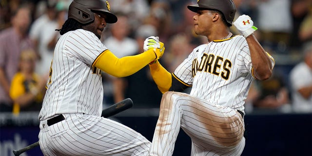 San Diego Padres' Juan Soto celebrates with Josh Bell after hitting a home run against the San Francisco Giants in the fourth inning of a baseball game, Tuesday, Aug. 9, 2022, in San Diego.