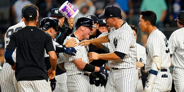 New York Yankees' Josh Donaldson, center, celebrates with teammates after hitting a walk-off grand slam during the tenth inning of a baseball game against the Tampa Bay Rays Wednesday, Aug. 17, 2022, in New York.