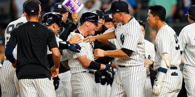 New York Yankees' Josh Donaldson, center, celebrates with teammates after hitting a walk-off grand slam during the tenth inning of a baseball game against the Tampa Bay Rays Wednesday, Aug. 17, 2022, in New York.