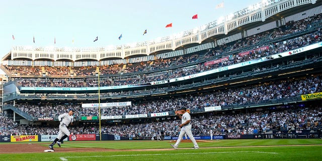 New York Yankees' Aaron Judge, left, runs the bases after hitting a two-run home run during the second inning of a baseball game against the Seattle Mariners, Monday, Aug. 1, 2022, in New York.