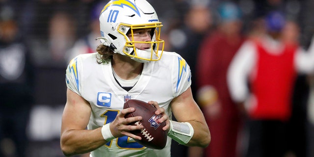 Quarterback Justin Herbert #10 of the Los Angeles Chargers looks to pass during a game against the Las Vegas Raiders at Allegiant Stadium on January 09, 2022 in Las Vegas, Nevada.