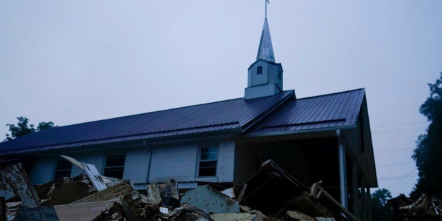 Piles of debris sit near a church after massive flooding on Friday, Aug. 5, 2022, in Lost Creek, Kentucky.