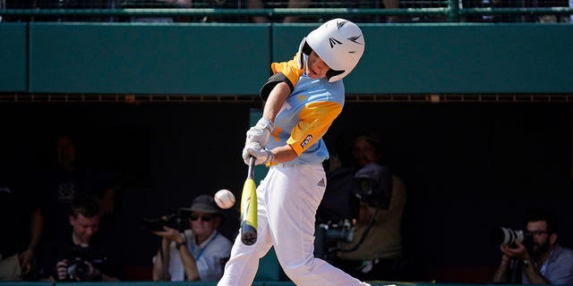 Honolulu's Kama Angell hits a solo home run off Curacao's Shemar Jacobus during the first inning of the Little League World Series championship game in South Williamsport, Pennsylvania, on Aug. 28, 2022.