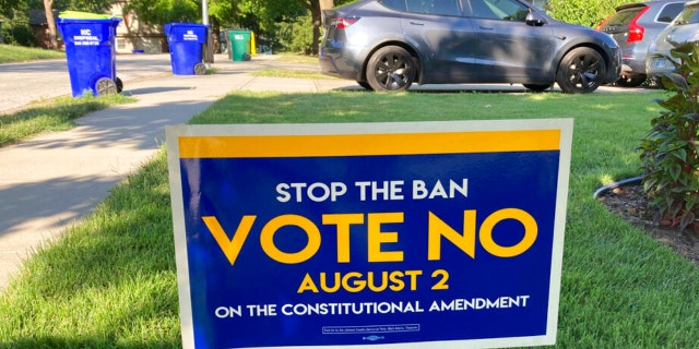 In this photo from Thursday, July 14, 2022, a sign in a yard in Merriam, Kansas, urges voters to oppose a proposed amendment to the Kansas Constitution to allow legislators to further restrict or ban abortion.