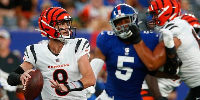 Cincinnati Bengals quarterback Brandon Allen, #8, throws a pass as New York Giants' Kayvon Thibodeaux, #5, rushes him during the first half of a preseason NFL football game Sunday, Aug. 21, 2022, in East Rutherford, N.J.