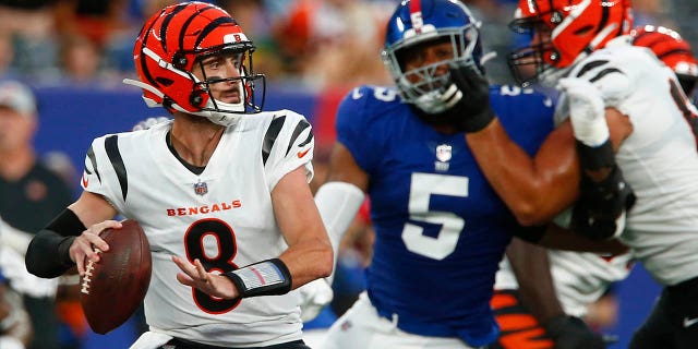 Cincinnati Bengals quarterback Brandon Allen, #8, throws a pass as New York Giants' Kayvon Thibodeaux, #5, rushes him during the first half of a preseason NFL football game Sunday, Aug. 21, 2022, in East Rutherford, N.J.