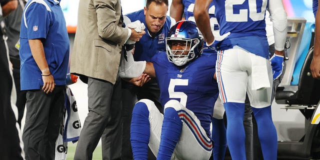 Kayvon Thibodeaux, #5 of the New York Giants, stands up after an apparent injury during the first half of a preseason game against the Cincinnati Bengals at MetLife Stadium on August 21, 2022 in East Rutherford, New Jersey. 