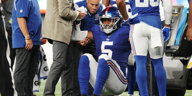 Kayvon Thibodeaux, #5 of the New York Giants, stands up after an apparent injury during the first half of a preseason game against the Cincinnati Bengals at MetLife Stadium on August 21, 2022 in East Rutherford, New Jersey. 