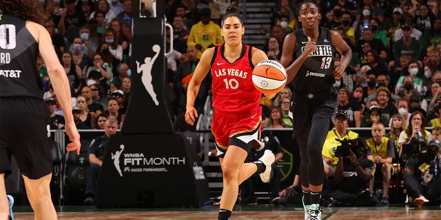 Kelsey Plum #10 of the Las Vegas Aces dribbles the ball during the game against the Seattle Storm on August 7, 2022 at the Climate Pledge Arena in Seattle, Washington.