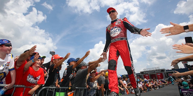 Kevin Harvick, driver of the Busch Light Apple No. 4 Ford, greets fans during driver intros prior to the NASCAR Cup Series FireKeepers Casino 400 at Michigan International Speedway, Aug. 7, 2022, in Brooklyn, Michigan.