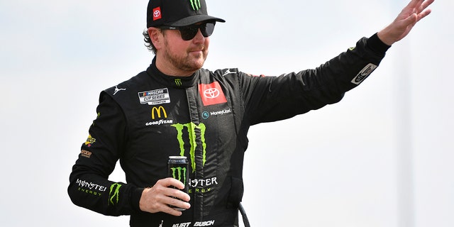 Kurt Busch, driver of the No. 45 Monster Energy Toyota, hands out to fans on the driver introduction stage before the NASCAR Cup Series Alley 400 at Nashville Superspeedway in Lebanon, Tennessee on June 26, 2022. waving