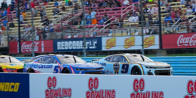 Chase Elliott, right, and Kyle Larson race for the lead during the NASCAR Cup Series Go Bowling at the Glen on Aug. 21, 2022, at Watkins Glen International in New York.