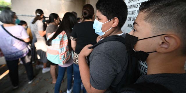 Students and parents arrive masked for the first day of school at Grant Elementary School in Los Angeles Aug. 16, 2021.
