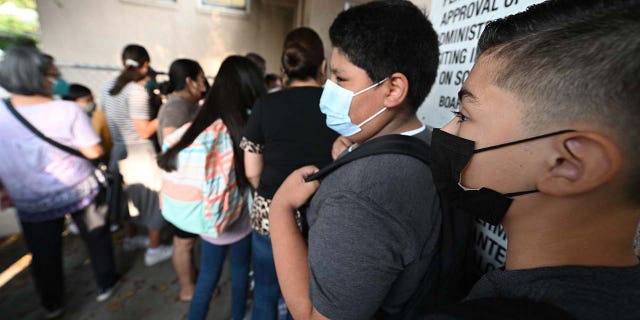 FILE: Students and parents arrive masked for the first day of the school year at Grant Elementary School in Los Angeles, California, August 16, 2021.