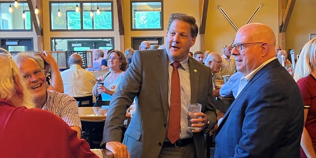 GOP Govs. Larry Hogan of Maryland (right) and Chris Sununu of New Hampshire (center) at a fundraiser for Republican state representatives, on August 30, 2022 in Manchester, N.H.