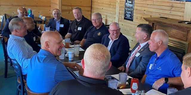 Maryland Governor Larry Hogan (center right) and Nebraska Rep. Don Bacon (left) hold a law enforcement roundtable on August 10, 2022 in Omaha, Nebraska.