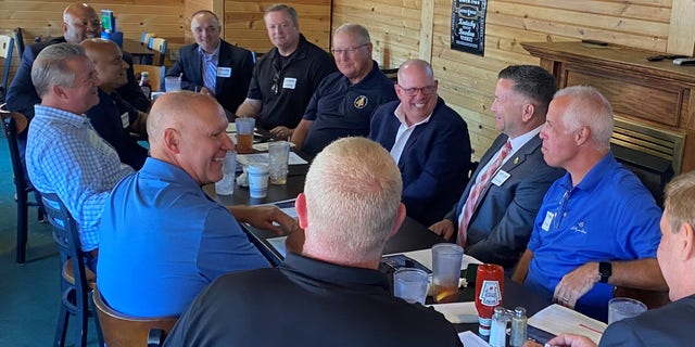 Maryland Governor Larry Hogan (center right) and Nebraska Rep. Don Bacon (left) hold a law enforcement roundtable on August 10, 2022 in Omaha, Nebraska.