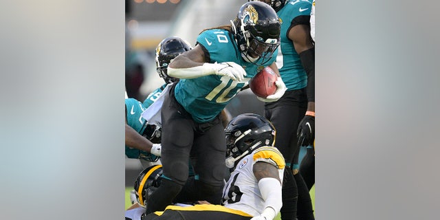 Jacksonville Jaguars wide receiver Laviska Shenault Jr. (10) recovers a fumble on a Pittsburgh Steelers punt return during the first half of an NFL preseason football game, Saturday, Aug. 20, 2022, in Jacksonville, Fla.