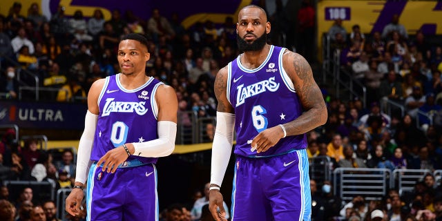 Russell Westbrook, left, and LeBron James of the Los Angeles Lakers look on during the game against the New Orleans Pelicans at Crypto.Com Arena in Los Angeles on April 1, 2022.