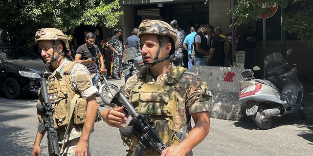 Lebanese security forces secure the area outside the bank where the hostage situation is unfolding.