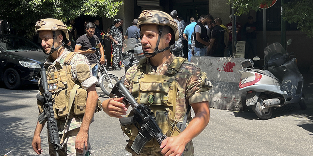 Lebanese security forces secure the area outside the bank where the hostage situation is unfolding.