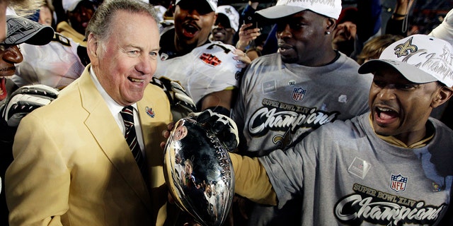 Former Kansas City Chiefs quarterback Len Dawson brings the Vince Lombardi Trophy onto the field as the New Orleans Saints beat the Indianapolis Colts 31-17, Sunday, February 7, 2010 in Super Bowl XLIV at Sun Life Stadium in Miami Gardens, Florida.