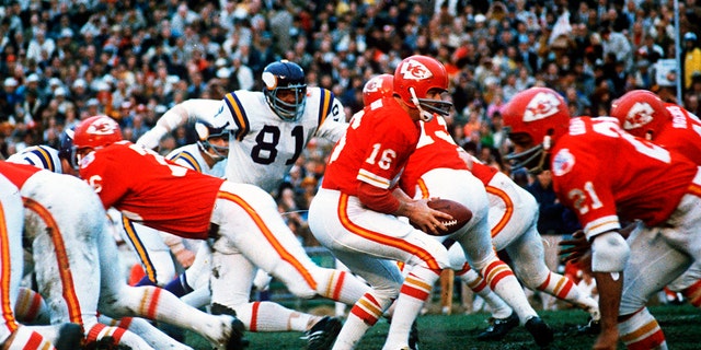 Kansas City Chiefs quarterback Len Dawson, #16, turns around to hand the ball off to running back Mike Garrett, #21, during the Super Bowl IV football game in New Orleans Jan. 11, 1970.