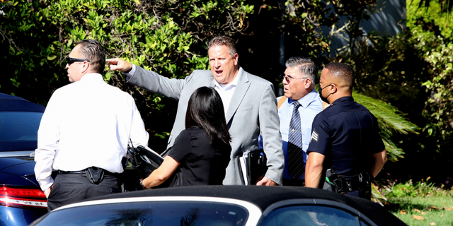 Law enforcement is seen gathering at the home following the robbery on Wednesday, August 17.