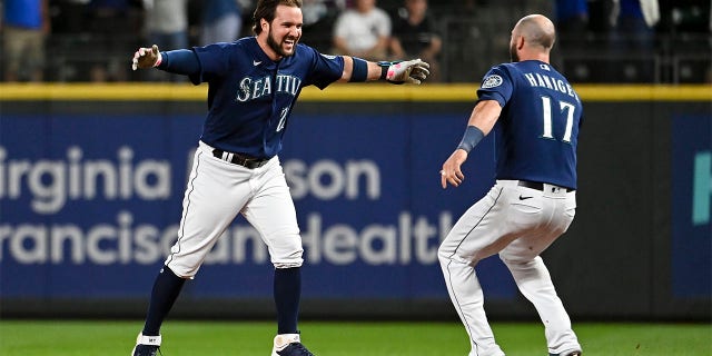 Mariners' Louis Torrance and Mitch Haniger celebrate after a game against the New York Yankees at T-Mobile Park on Aug. 9, 2022, in Seattle.