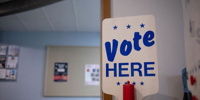 "Vote Here" sign is seen at a Michigan voting precinct in August 2022. 