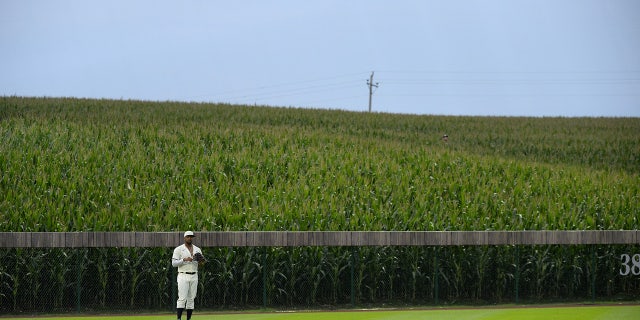 Eloy Jimenez, #74 of the Chicago White Sox, looks on while fielding against the New York Yankees on August 12, 2021 at Field of Dreams in Dyersville, 아이오와.
