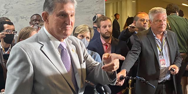 Sen. Joe Manchin, DW.Va., speaks to a reporter during a news conference on the Democrats' reconciliation bill. 