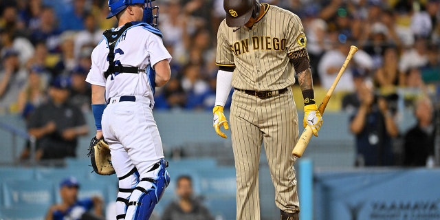 San Diego Padres third baseman Manny Machado hangs his head after being called out on strikes in the sixth inning of a game against the Los Angeles Dodgers at Dodger Stadium in Los Angeles on Aug. 5, 2022.