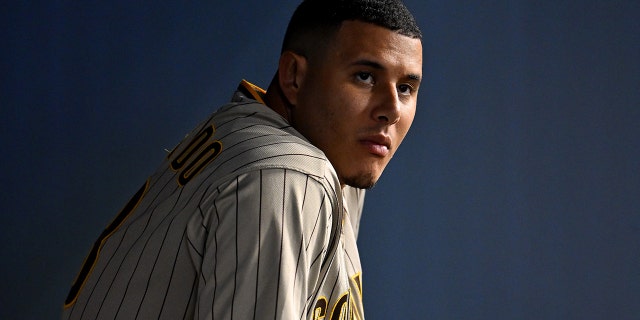 San Diego Padres third baseman Manny Machado, #13, looks on from the dugout during the fifth inning against the Los Angeles Dodgers at Dodger Stadium in Los Angeles Aug. 5, 2022.