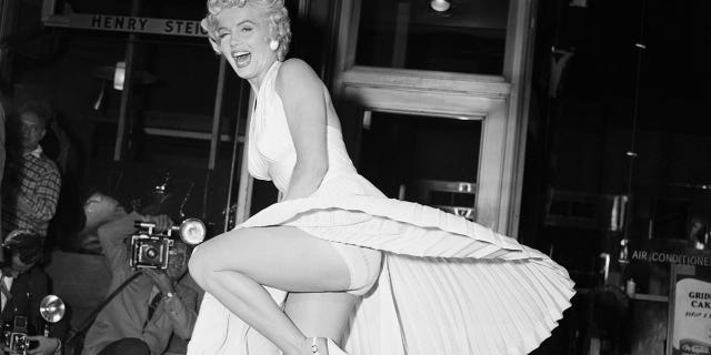 Film star Marilyn Monroe poses over a Manhattan subway grate as the wind blows her white dress up. Photographers capture the moment on camera, which takes place on Sept. 16, 1954, during the filming of "Seven Year Itch." Reportedly, Monroe's husband Joe DiMaggio was displeased at the attention his wife received from the crowds.