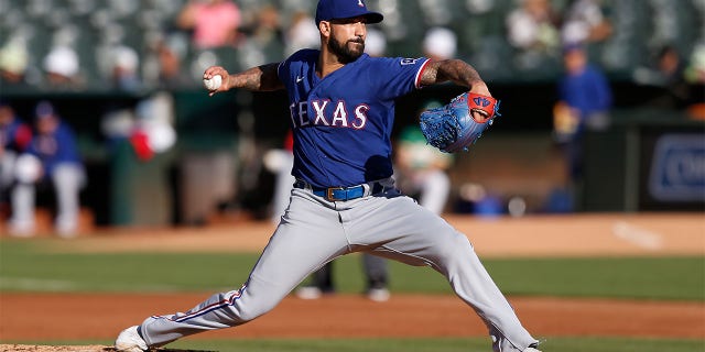 Matt Bush #51 of the Texas Rangers pitches against the Oakland Athletics at RingCentral Coliseum on July 23, 2022 in Oakland, California.