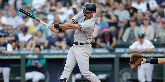 New York Yankees' Matt Carpenter hits a foul ball off his foot against the Seattle Mariners during the first inning of a baseball game, Monday, Aug. 8, 2022, in Seattle. He left the game after his at bat. 
