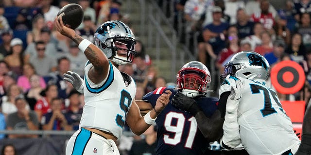 Carolina Panthers quarterback Matt Corral passes under pressure from New England Patriots defensive end Dietrich Wise Jr. on Friday, Aug. 19, 2022 in Foxborough, Massachusetts.