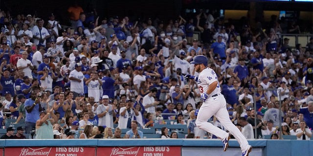 Los Angeles Dodgers' Max Muncy rounds third after hitting a solo home run during the second inning of a baseball game against the Minnesota Twins Wednesday, Aug. 10, 2022, in Los Angeles. 