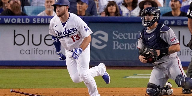 Los Angeles Dodgers' Max Muncy, left, heads to first as he hits a solo home run as Minnesota Twins catcher Gary Sanchez watches during the second inning of a baseball game Wednesday, Aug. 10, 2022, in Los Angeles.