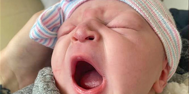 Levi Rylee Rose McCollum, daughter of fallen Wyoming Marine Rylee McCollum, yawns in his grandmother's arms. (Jill Miller Crayton via Facebook)