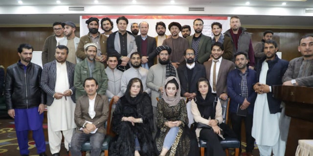 Meena Habib and others pose for a photo in December 2021 with the former Interior Ministry spokesman before he was fired.