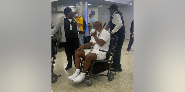 Mike Tyson in a wheelchair at Miami International Airport Aug. 16, 2022.