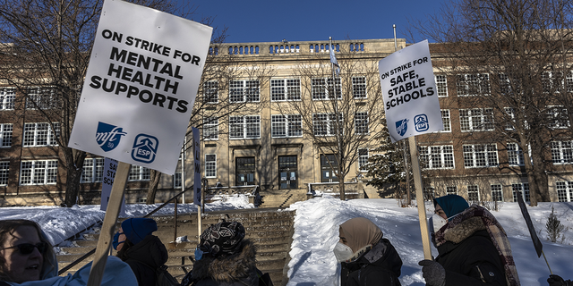 Minneapolis school teachers hold placards during the strike in front of the Justice Page Middle school in Minneapolis, Minnesota, United States on March 8, 2022. 