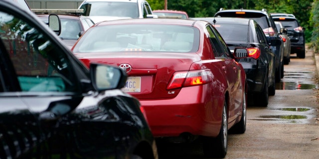 Area residents line up at the city's downtown fire station to receive bottled water, Aug. 18, 2022, as part of Jackson, Miss., response to longstanding water system problems.